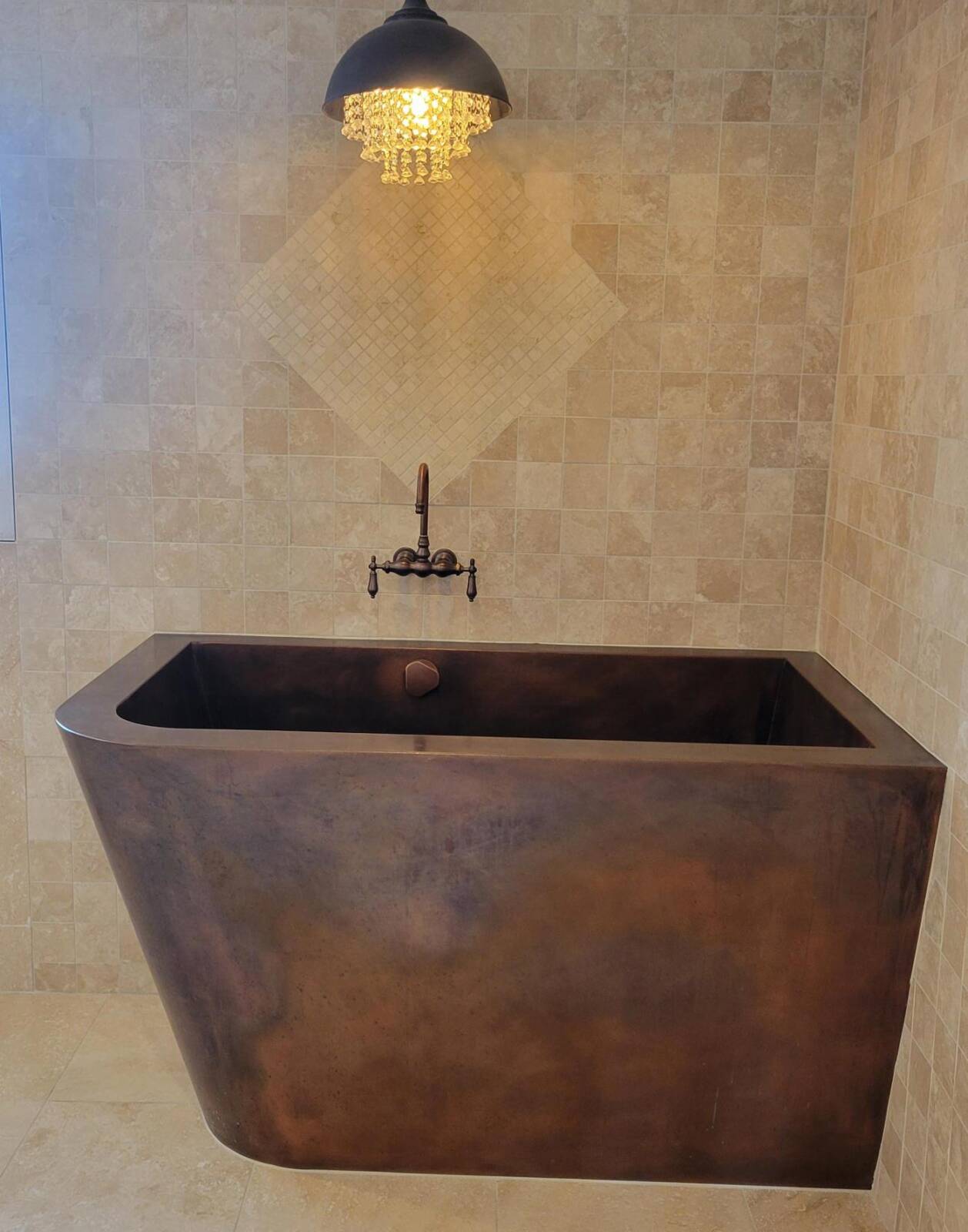 Custom copper Japanese bath with two-sided tapered skirting and bench seating.  42”x 60”x 36”