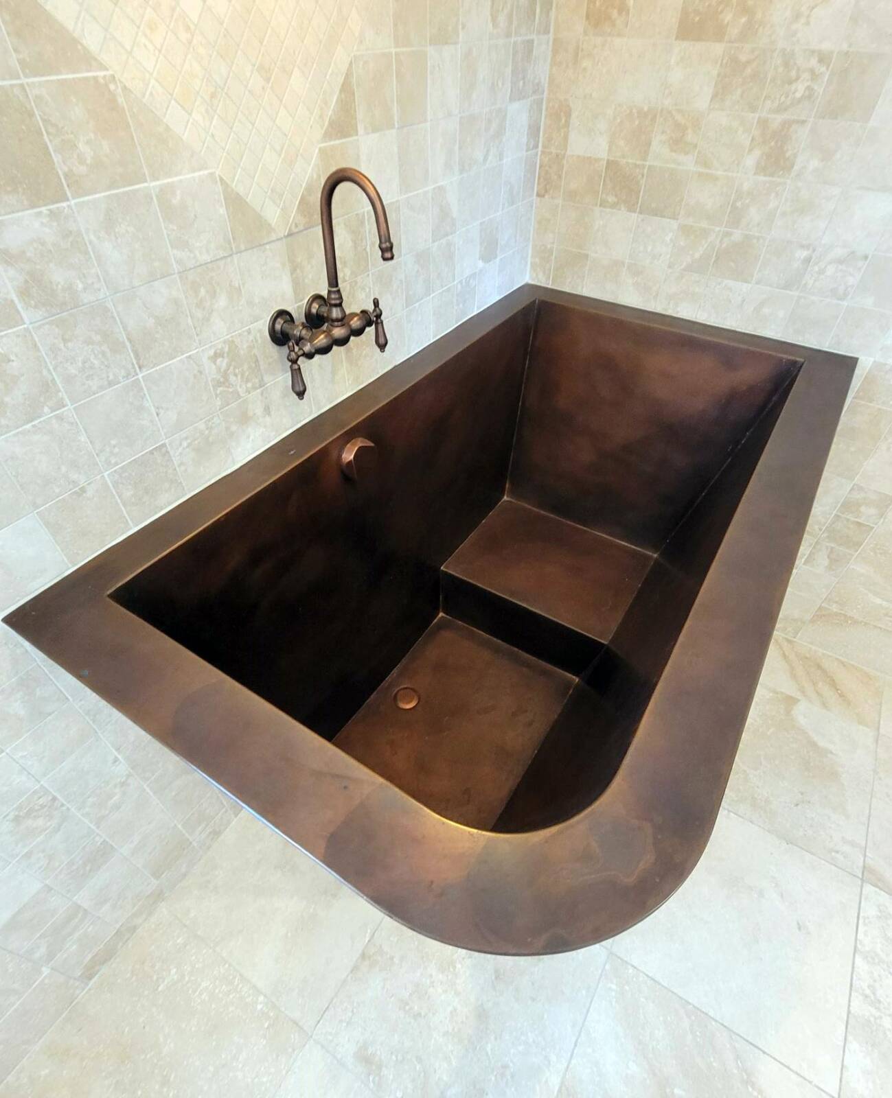 Custom copper Japanese bath with two-sided tapered skirting and bench seating.  42”x 60”x 36”