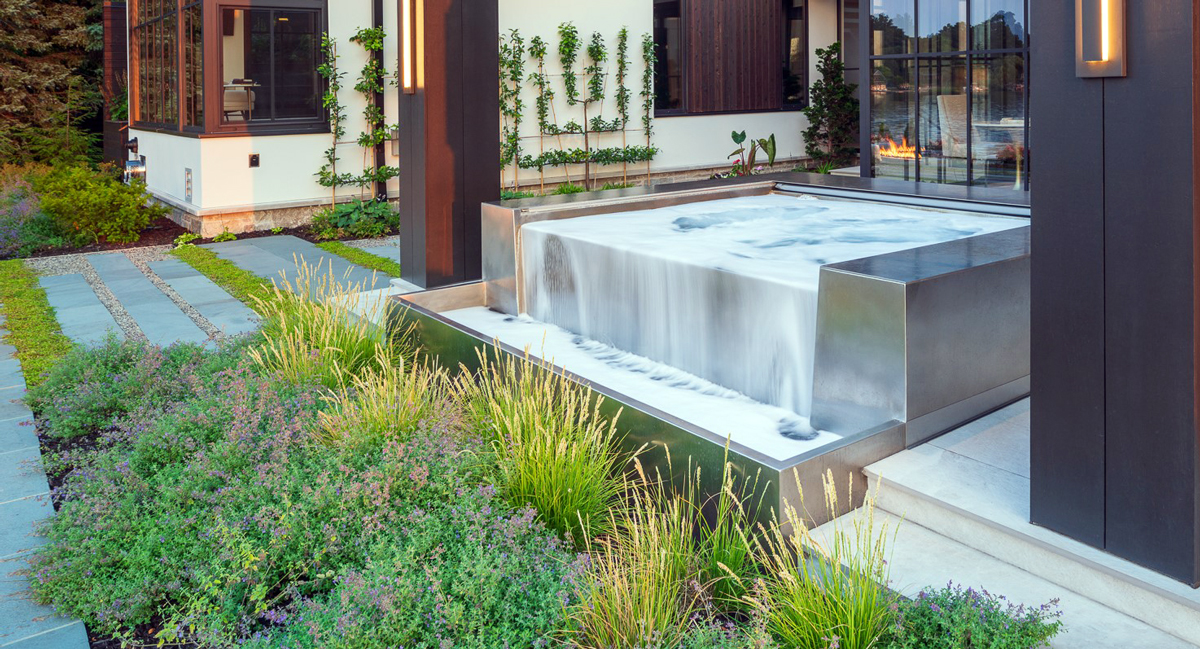 Custom Stainless Steel Spa 81” x 87” x 42” with bench seating.  Custom stainless steel water feature 40”x 67” with a 36” water spout.