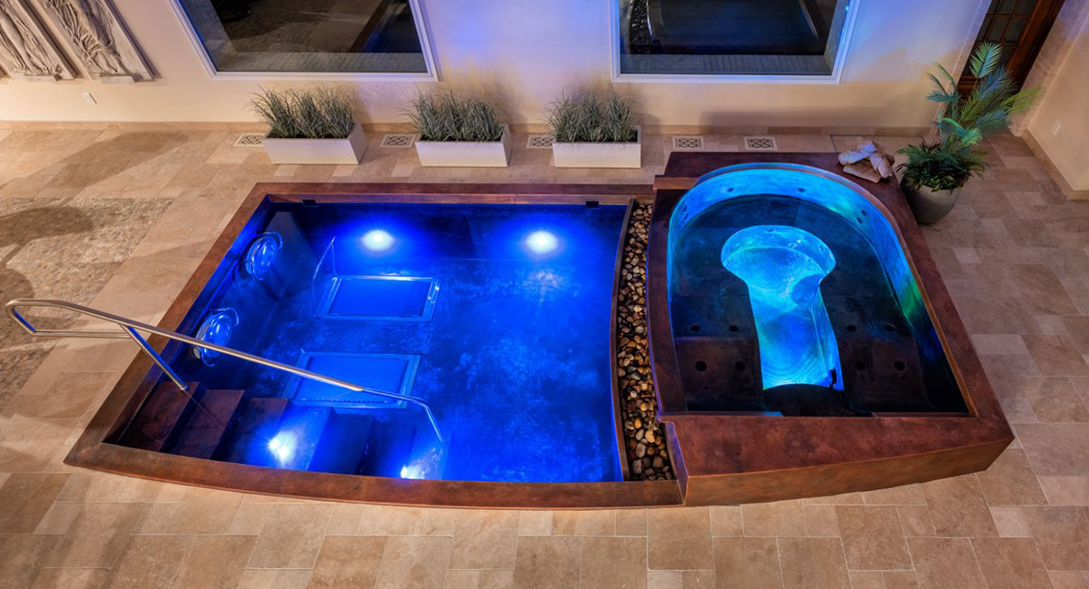 Copper pool and spa.  The pool has an interior descending stairway and two underwater hydraulic treadmills with swim jet systems and LED lighting.  The spa has LED lighting, front spill over water feature, two loungers and bench seating.  133