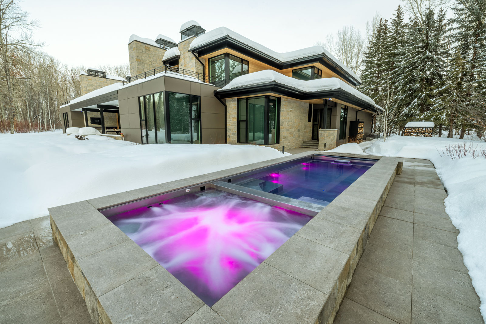 Stainless steel pool with swim spa system, neighboring spa with bench seating, LED lighting and automatic cover. 122” x 352” x 58”